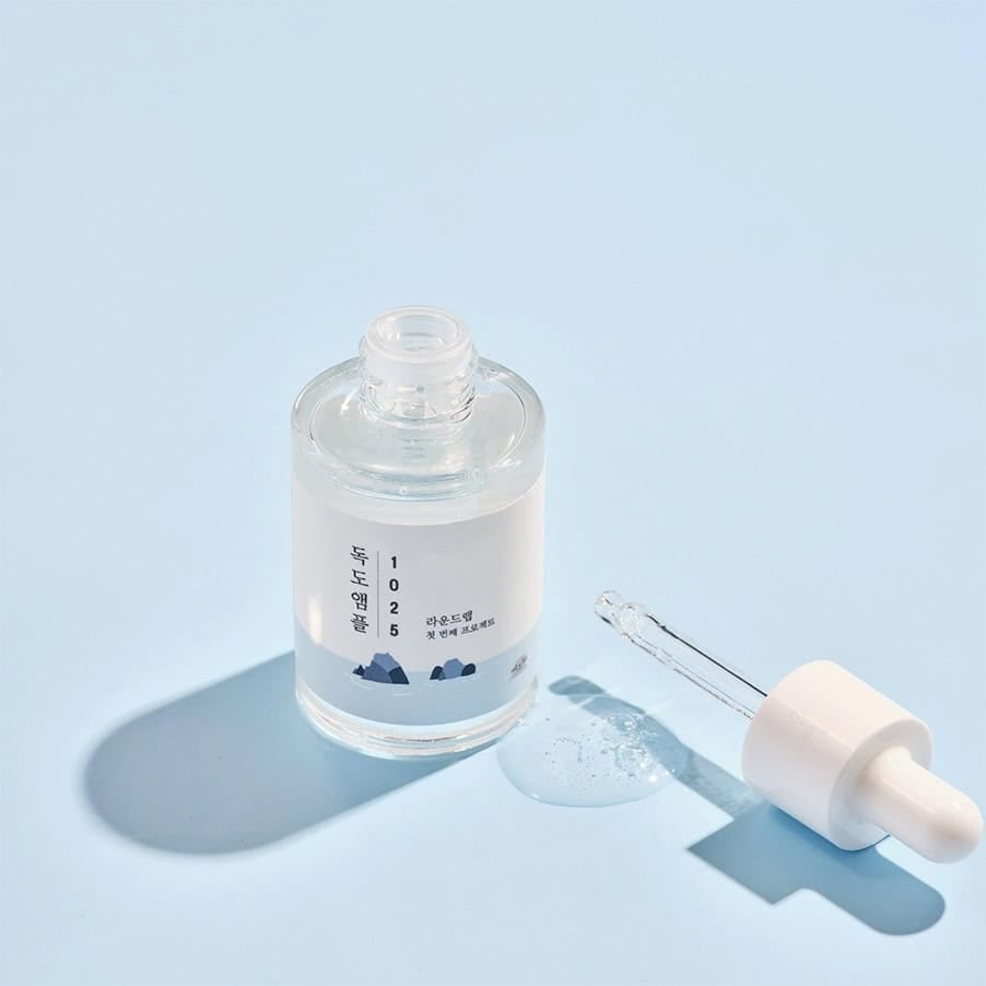 Frasco da 1025 Dokdo Ampola 200ml da Round Lab, tratamento intensivo para hidratação profunda e fortalecimento da barreira cutânea.